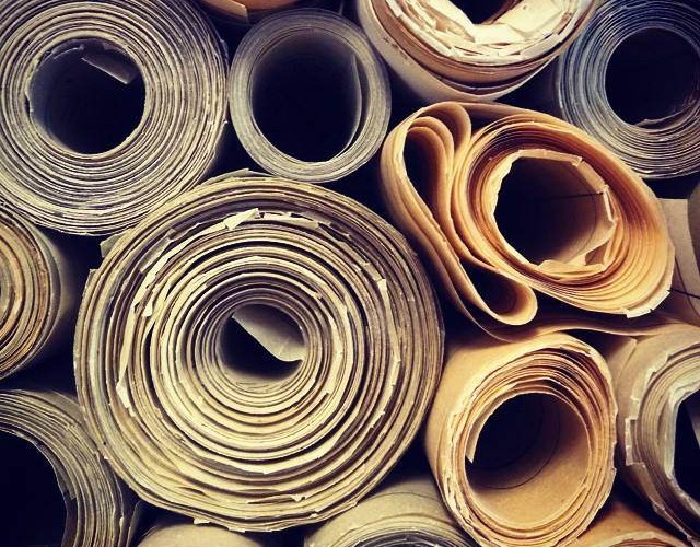A stack of rolled drawings, viewed in profile.