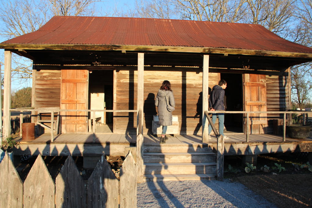 Grinnell College students examine a double-pen slave cabin in Vacherie, Louisiana.