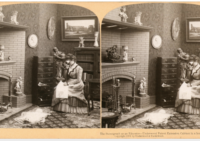 A sepia-toned stereoscopic image from the turn of the twentieth century depicts a woman in a drawing room, herself looking into a stereoscope.