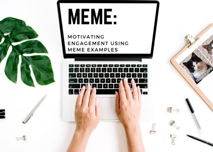 Two hands type at a computer, which reads MEME: Motivating Engagement using Meme Examples. Next to the hands is a clipboard with a print-out of a cat-based meme on it.