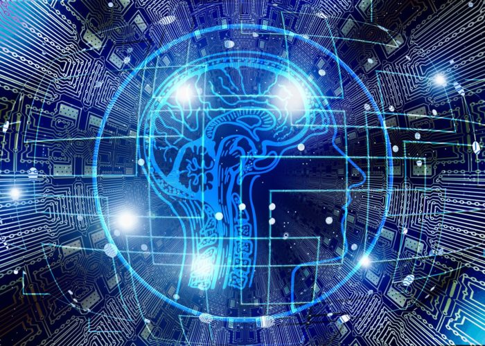 A cross-section of a brain appears in blue light over a dark background, with nodes and lines of light giving the impression of interlinked computer circuits.