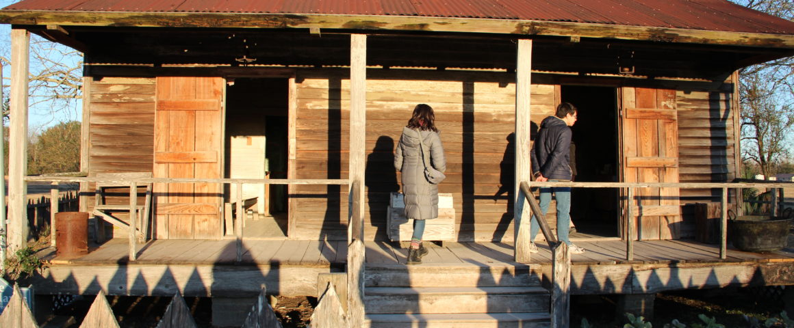 Grinnell College students examine a double-pen slave cabin in Vacherie, Louisiana.