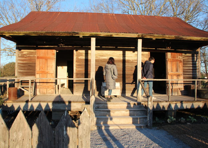 Grinnell College students examine a double-pen slave cabin in Vacherie, Louisiana.