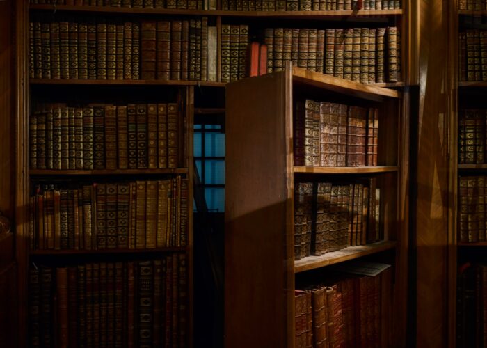 A bookcase opens to reveal a secret passageway.